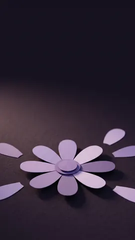 A paper daisy in Appoint Me lavender on a dark background, with space at the top for captions