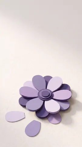 A paper daisy in Appoint Me lavender on a light background, with space at the top for captions